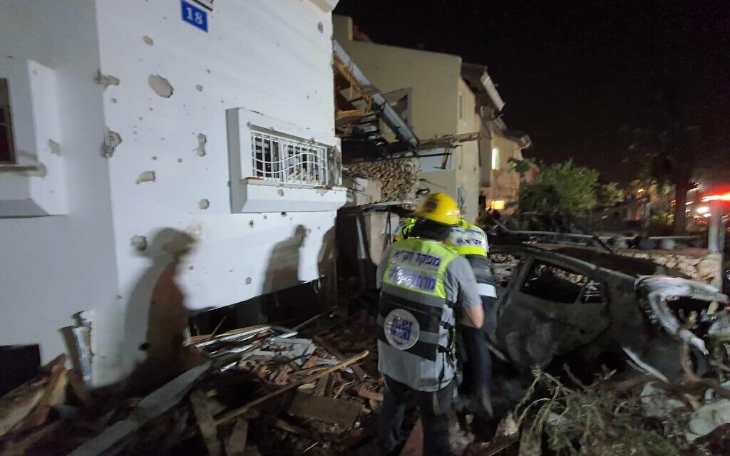 Emergency service workers look through the rubble of a house struck by a Hamas rocket. 

Images: Credit ZAKA