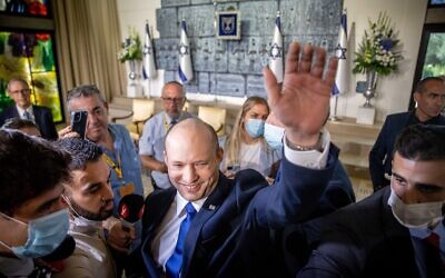 The new Israeli Prime Minister Naftali Bennett waves during a joint photo with the new government ministers at the President's residence in Jerusalem. Photo by: JINIPIX