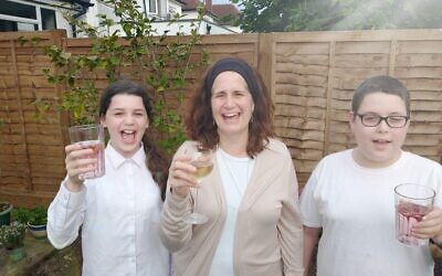 Fiona Palmer with two of her children raising a glass to pay tribute to veterans, say thank you to HM Armed Forces and honour British Jewish servicemen and women