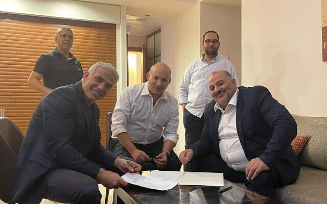 Yair Lapid, Naftali Bennett and Mansour Abbas were among eight party leaders who agreed the coalition deal. (Photo: Twitter)