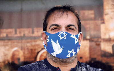 Man wearing a face mask decorated with the Jewish Star of David due to the COVID-19 coronavirus pandemic