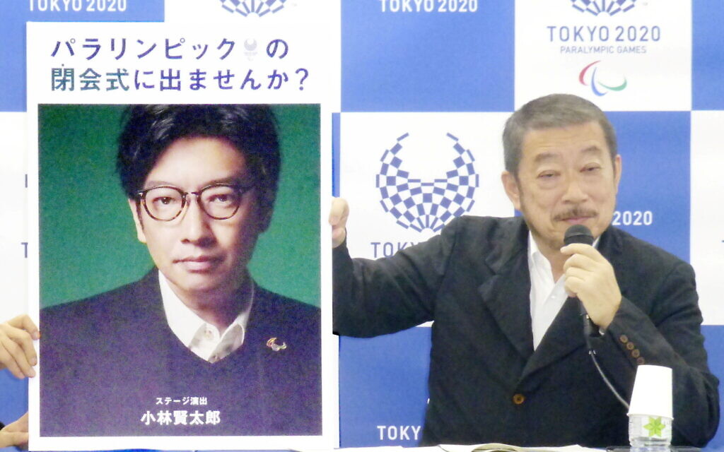 A photograph of Olympics opening ceremony show director Kentaro Kobayashi held up by a Paralympics Games executive in December 2019 (Photo: Kyodo via Reuters)