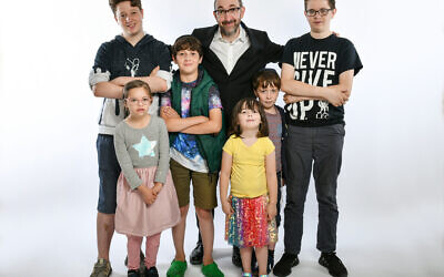 Ashley Blaker with his brood of half a dozen children, three of whom have special needs