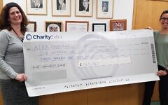 Fiona Palmer, AJEX, Chief Executive and Deborah Field, AJEX Campaign manager proudly holding the CharityExtra cheque from generous donors