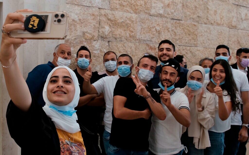 Palestinian residents of Sheikh Jarrah take a selfie on Monday before attending a petition regarding evacuation from their home in Sheikh Jarrah neighborhood, at the Supreme Court