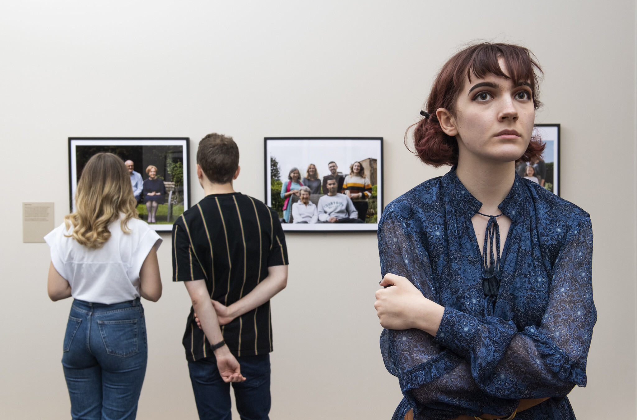 Visitors explore Generations: Portraits of Holocaust Survivors at IWM London. © IWM