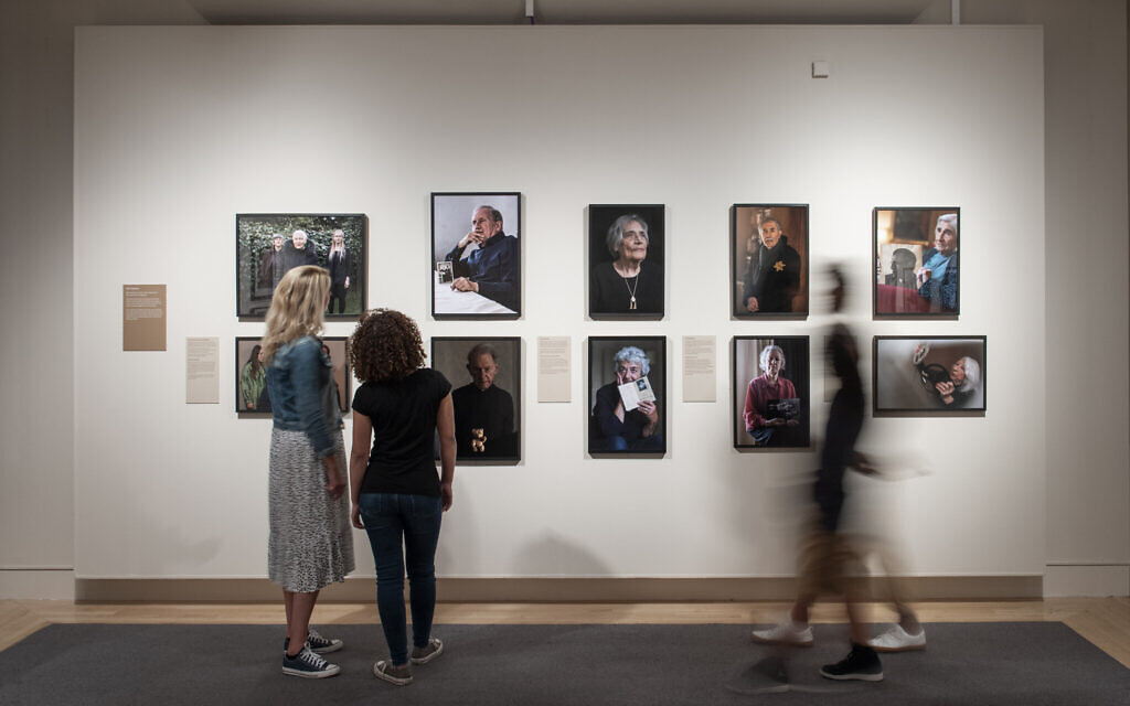 Visitors explore Generations: Portraits of Holocaust Survivors at IWM London. © IWM