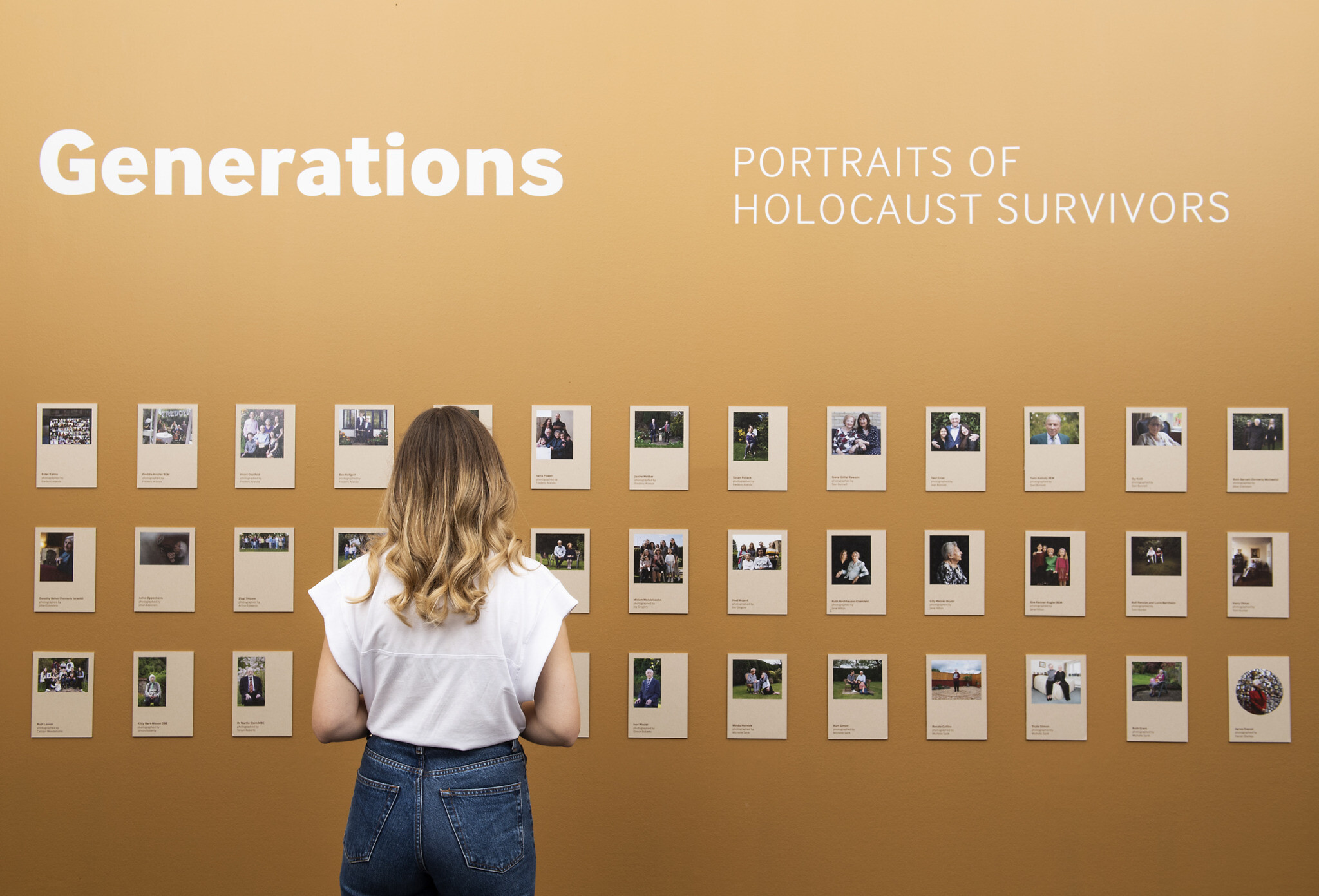 © IWM (1471)
A visitor explores Generations: Portraits of Holocaust Survivors at IWM London.