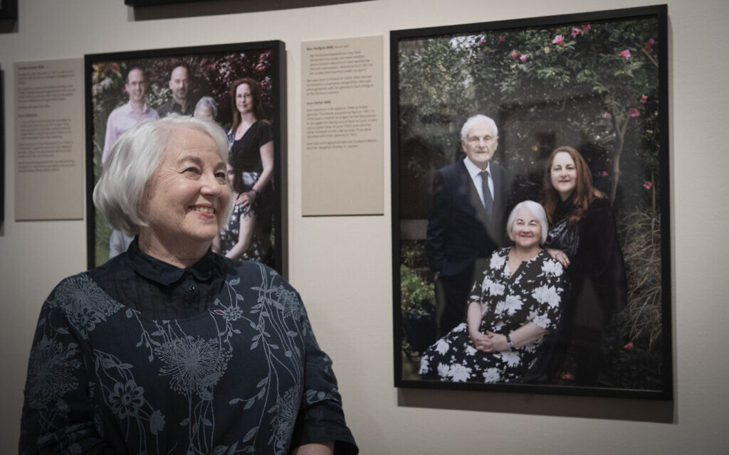 Joan Salter MBE sits alongside her portrait by Frederic Aranda, exhibited at IWM London as part of Generations: Portraits of Holocaust Survivors.© IWM