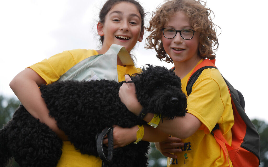 More than a hundred brightly dressed walkers put their best feet forward and raised £50,000 in memory of five-year-old Shani Berman, from Elstree, who died from a rare heart condition
