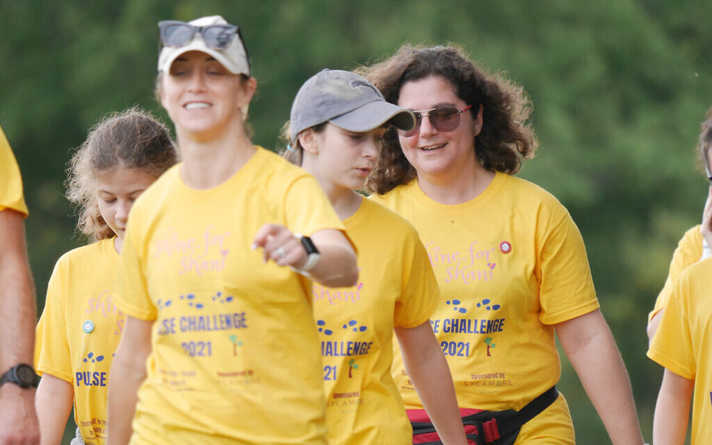 More than a hundred brightly dressed walkers put their best feet forward and raised £50,000 in memory of five-year-old Shani Berman, from Elstree, who died from a rare heart condition. Her mother, Juliet, pictured right, organised the fundraiser