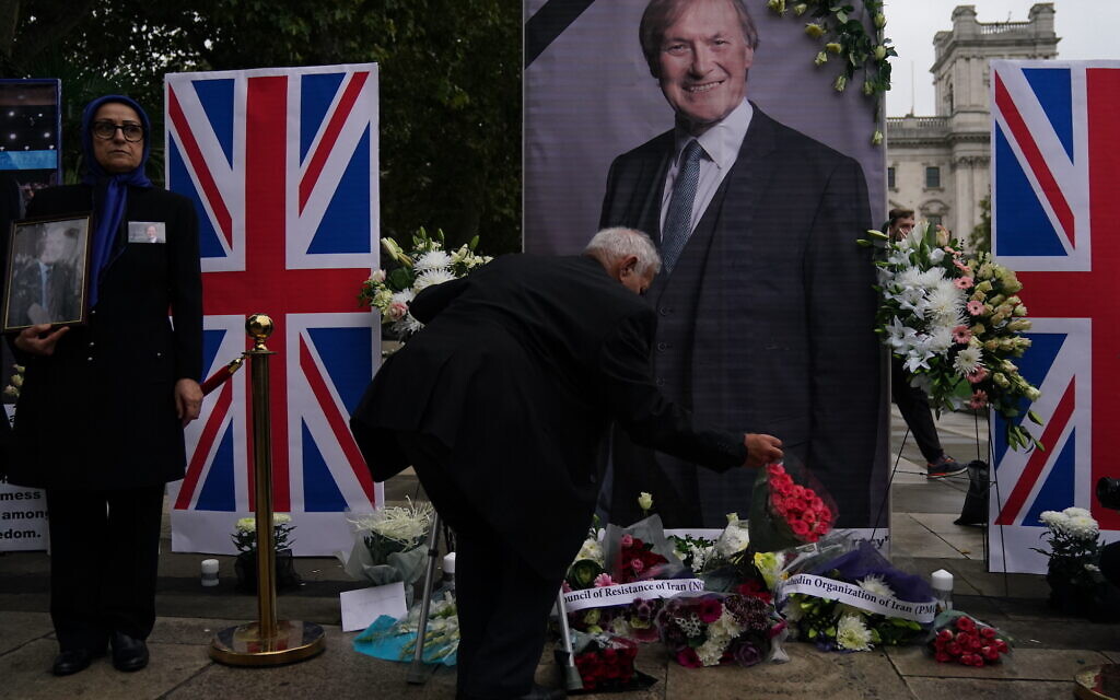 People from the UK Iranian community hold a vigil for Sir David Amess, in Parliament Square, London. Picture date: Monday October 18, 2021.