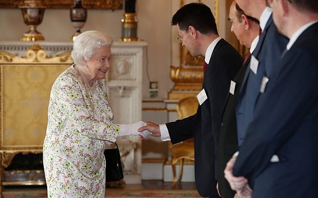 Queen Elizabeth II greets Housing Secretary James Brokenshire during a reception at Buckingham Palace, London, to celebrate the work of UK faith and belief groups in bringing local communities together. Photo credit: Jonathan Brady/PA Wire