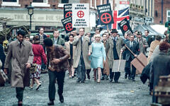 Scene from Ridley Road shows Colin Jordan (Rory Kinnear), Vivien Epstein (Agnes O'Casey) marching towards a Synagogue.- (C) Red Productions - Photographer: Ben Blackall Scene from Ridley Road shows Colin Jordan (Rory Kinnear), Vivien Epstein (Agnes O'Casey) marching towards a Synagogue.- (C) Red Productions - Photographer: Ben Blackall