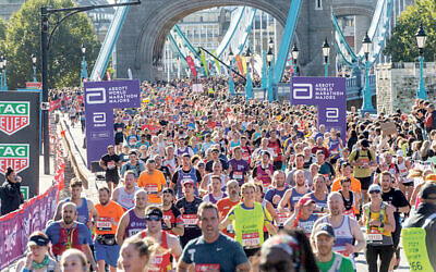 Runners run across Tower Bridge during the London Marathon 2021. Photo by Ray Tang.