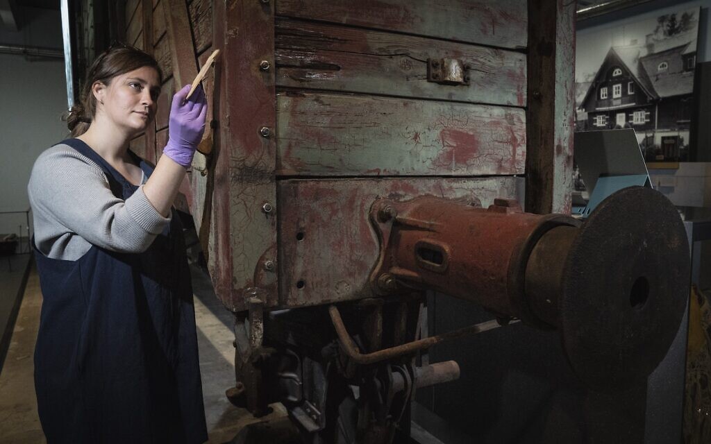 Preservation Technician Emily Thomas cleans a rail wagon of the type used to transport victims to death camps. Pictured in The Holocaust Gallery at IWM London, Lambeth Road.
Photographed 30th Sept 2021