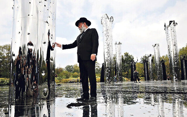 A visitor to the installation Crystal Wall of Crying, in memory of the massacre at Babyn Yar