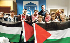 Members of a student BDS campaign in Dublin holding Palestinian flags.