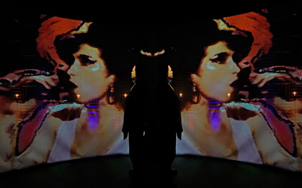 A visitor looks at an immersive installation at an exhibition titled 'Amy: Beyond the Stage' at the Design Museum in London. Picture date: Wednesday November 24, 2021.