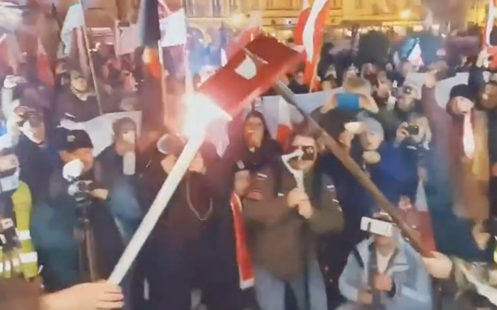 Nationalist rally-goers burn a book in Kalisz, Poland, Nov. 11, 2021. (Karolina Pawliczak/Twitter)