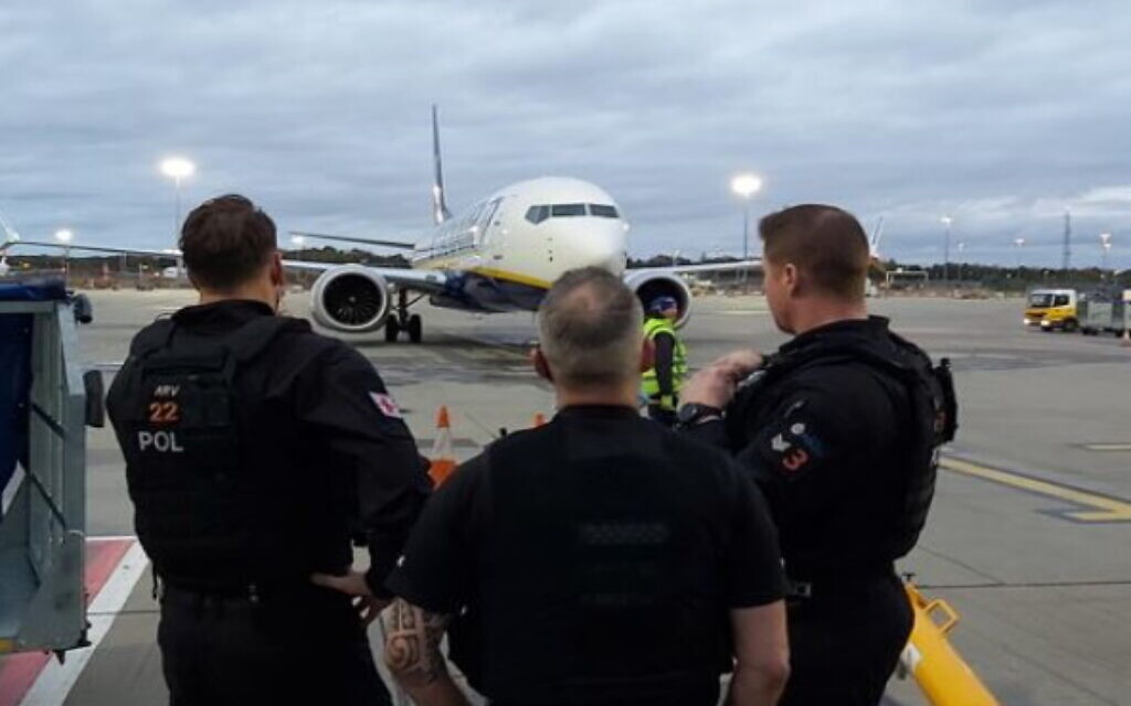 Essex Police image, waiting at Stanstead airport to arrest a West Ham supporter being arrested over alleged antisemitic chanting