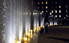 Vienna, Austria.  People commemorate victims at Shoah Wall of Names Memorial in Vienna, Austria, on Nov. 9, 2021. Shoah Wall of Names Memorial was inaugurated at Ostarrichi Park in Vienna on Tuesday. The new memorial commemorates more than 64,000 Jews from Austria who were murdered or perished during the Nazi era. Credit: Guo Chen/Xinhua/Alamy Live News