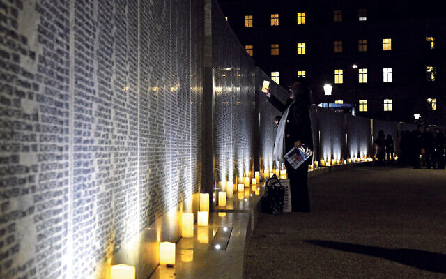 Vienna, Austria.  People commemorate victims at Shoah Wall of Names Memorial in Vienna, Austria, on Nov. 9, 2021. Shoah Wall of Names Memorial was inaugurated at Ostarrichi Park in Vienna on Tuesday. The new memorial commemorates more than 64,000 Jews from Austria who were murdered or perished during the Nazi era. Credit: Guo Chen/Xinhua/Alamy Live News