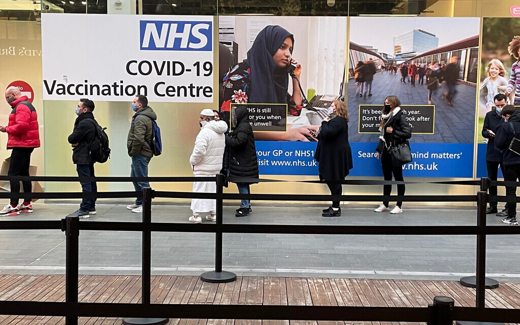 People queue at a COVID Vaccination Centre at the Westfield shopping centre in Stratford, east London,