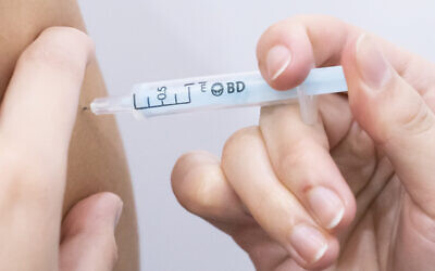 A booster coronavirus vaccine is administered at a Covid vaccination centre at Elland Road in Leeds, as the booster vaccination programme continues across the UK. Picture date: Tuesday December 21, 2021.
