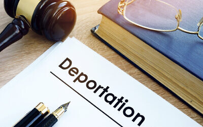 Deportation and other documents on a desk.