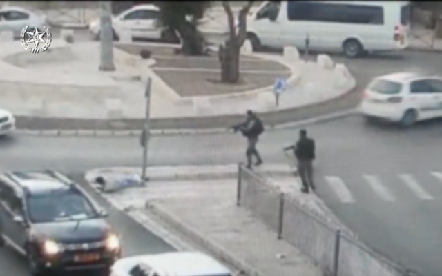 Assailant lies on the ground after being shot by Israeli police