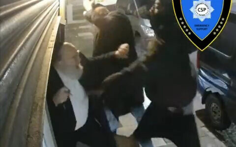 Screengrab dated 26/01/22 taken with permission from video posted on twitter by @Shomrim of a teenager attacking two Jewish men while they were locking up their shop in Cadoxton Avenue, Haringey, London. Issue date: Thursday January 27, 2022.
