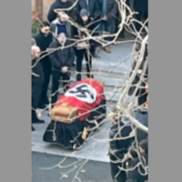 A view of the casket draped in a Nazi flag in Rome, Jan. 11, 2022. (Screenshot from Open)