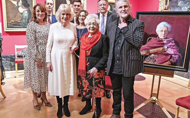 EMBARGOED TO 2230 WEDNESDAY JANUARY 26 The Duchess of Cornwall with Holocaust survivor Helen Aronson (centre) and her family, and artist Paul Benney (right) beside the portrait of Helen during an exhibition at The Queen's Gallery, Buckingham Palace, London, of 'Seven Portraits: Surviving the Holocaust', which were commissioned by the Prince of Wales to pay tribute to Holocaust survivors. Picture date: Monday January 24, 2022.
