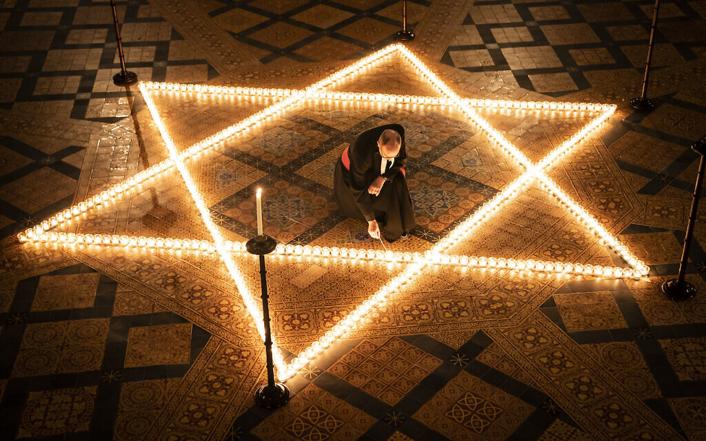 The Reverend Canon Michael Smith, Acting Dean of York, helps light six hundred candles in the shape of the Star of David, in memory of more than 6 million Jewish people murdered by the Nazis in the Second World War, in the Chapter House at York Minster in York, part of York Minster's commemoration for International Holocaust Day.