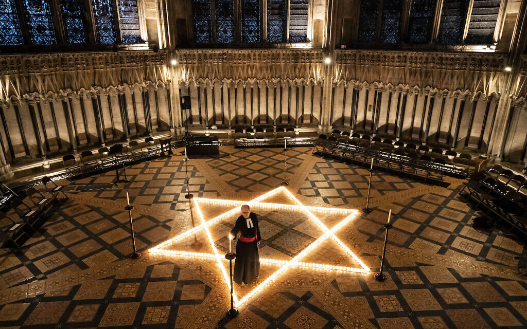 The Reverend Canon Michael Smith, Acting Dean of York, helps light six hundred candles in the shape of the Star of David, in memory of more than 6 million Jewish people murdered by the Nazis in the Second World War, in the Chapter House at York Minster in York, part of York Minster's commemoration for International Holocaust Day.