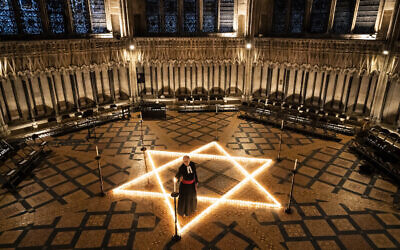 The Reverend Canon Michael Smith, Acting Dean of York, helps light six hundred candles in the shape of the Star of David, in memory of more than 6 million Jewish people murdered by the Nazis in the Second World War, in the Chapter House at York Minster in York, part of York Minster's commemoration for International Holocaust Day. Picture date: Wednesday January 26, 2022.