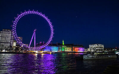 A view of the London Eye in Westminster, lit up in purple for Holocaust Memorial Day.