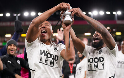 Boreham Wood's Adrian Clifton (left) and Tyrone Marsh celebrate with the fans while holding a miniature replica FA Cup trophy after victory in the Emirates FA Cup fourth round match at the Vitality Stadium, Bournemouth. Picture date: Sunday February 6, 2022.