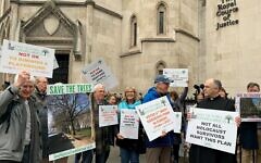 Protesters outside the Royal Courts of Justice in central London ahead of a hearing regarding the UK Holocaust Memorial. The London Historic Parks and Gardens Trust is opposed to a new UK Holocaust Memorial and Learning Centre being built in Victoria Tower Gardens, a small triangular Grade II-listed park next to Westminster Abbey and the Palace of Westminster. Issue date: Tuesday February 22, 2022. Protesters outside the Royal Courts of Justice in central London ahead of a hearing regarding the UK Holocaust Memorial. The London Historic Parks and Gardens Trust is opposed to a new UK Holocaust Memorial and Learning Centre being built in Victoria Tower Gardens, a small triangular Grade II-listed park next to Westminster Abbey and the Palace of Westminster. Issue date: Tuesday February 22, 2022.