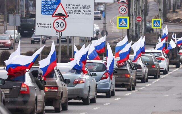 Vehicles carrying Russian flags are pictured in central Donetsk as city residents celebrate sovereign Ukrainian land being recognised as the Donetsk People's Republic by Russia. Vehicles carrying Russian flags are pictured in central Donetsk as city residents celebrate sovereign Ukrainian land being recognised as the Donetsk People's Republic by Russia.