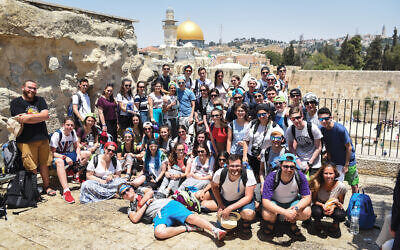 Israel tour with the Kotel and Dome of the Rock in the background.
