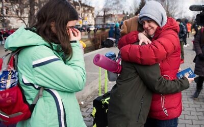 2HTH644 Przemysl, Poland. 28th Feb, 2022. People are seen crying while hugging after they found their relatives waiting for them at the train station in Przemysl.On the fifth day of the Russian invasion on Ukraine, thousands of asylum seekers arrive by trains to Przemy?l. Each train's capacity is estimated at two thousand people. Credit: SOPA Images Limited/Alamy Live News