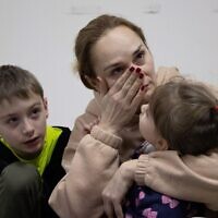 A woman cries next to her children in a Kyiv bomb shelter. . Photo by Raphael Lafargue/ABACAPRESS.COM