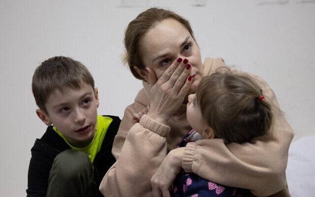 A woman cries next to her children in a Kyiv bomb shelter. . Photo by Raphael Lafargue/ABACAPRESS.COM
