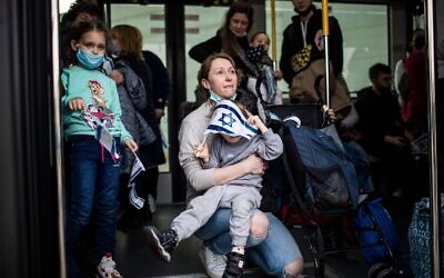 A Jewish Ukrainian immigrant holds her baby after disembarking from an airplane at Ben Gurion international airport, 6 March 2022. Credit: ilia Yefimovich/dpa/Alamy Live News