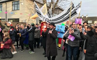 Rabbi Baruch Levin carries a new Torah scroll through the streets of Willesden during the celebrations of the new Brondesbury Park synagogue. (Lee Harpin)