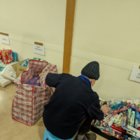 A volunteer at Barnet Synagogue prepares packages of aid for Ukrainian refugees, March 2022.