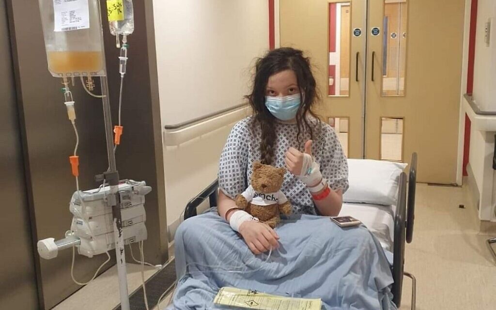 Abi Jacobs holding a Camp Simcha teddy which she kept with her throughout her time in hospital.