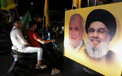 A poster depicting Hezbollah leader Sayyed Hassan Nasrallah and Head of Hezbollah's parliamentary bloc Mohamed Raad in Nabatiyeh, southern Lebanon, in 2022 (Photo: Reuters/Issam Abdallah)